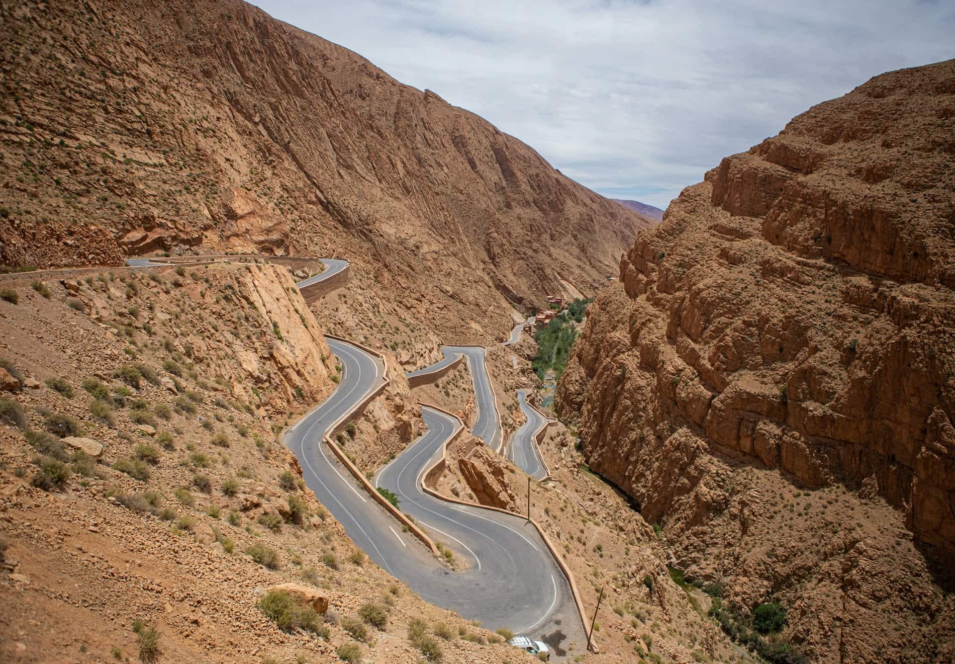 The road into the Dades Gorges climbing in tight hairpin bends between steep, eroded rock walls.